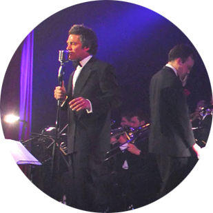 Tom Rust sing with big band in circular picture